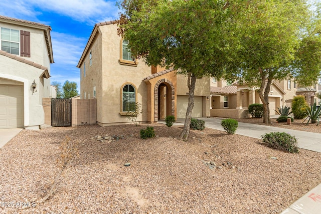 view of front of house featuring driveway, a gate, and stucco siding