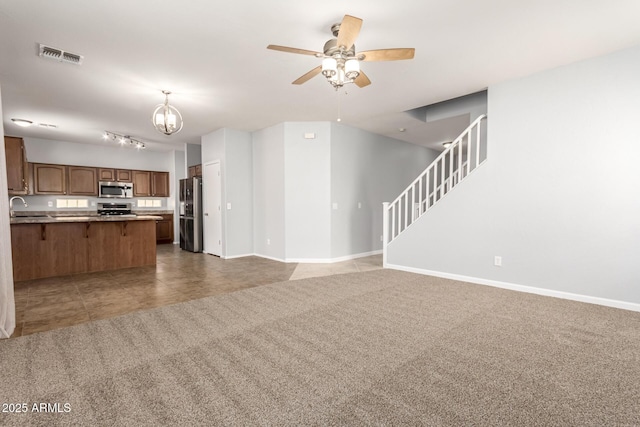 kitchen featuring a sink, light carpet, open floor plan, stainless steel appliances, and visible vents