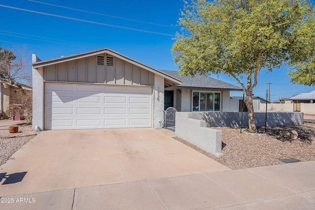 single story home featuring fence, driveway, an attached garage, a shingled roof, and board and batten siding