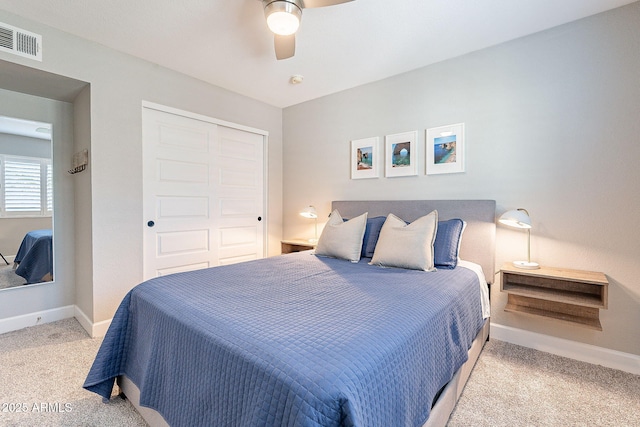 carpeted bedroom featuring a ceiling fan, baseboards, visible vents, and a closet