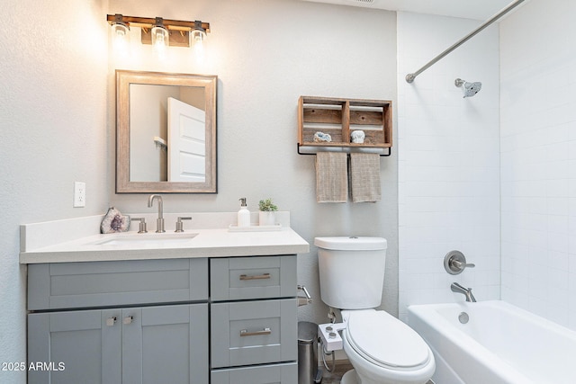 bathroom featuring shower / washtub combination, toilet, and vanity