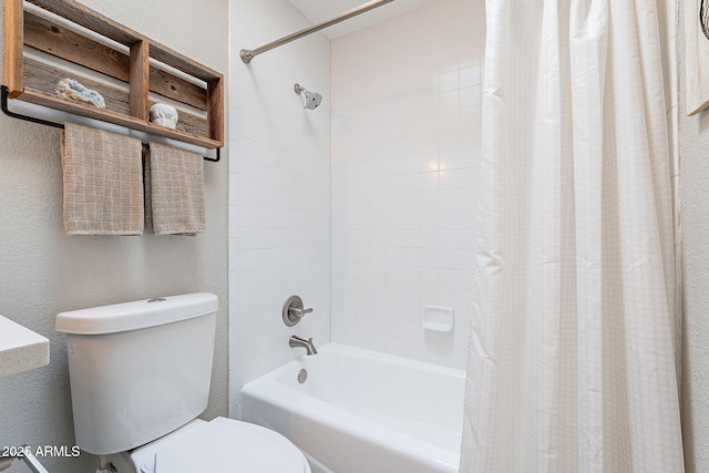 full bath with toilet, shower / tub combo with curtain, and a textured wall