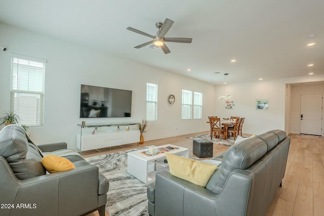 living room featuring light wood-type flooring and ceiling fan