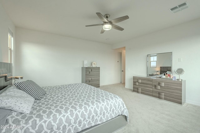 bedroom featuring ceiling fan and light carpet