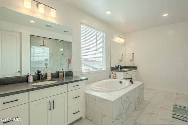 bathroom with vanity and a tile shower