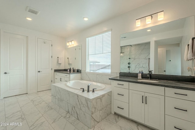 bathroom featuring vanity and shower with separate bathtub