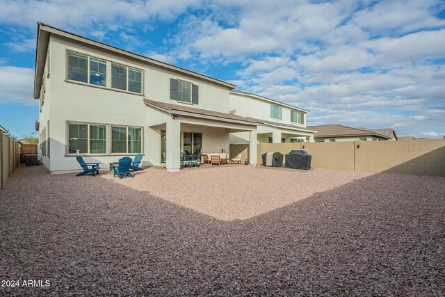 rear view of house featuring a patio and central AC