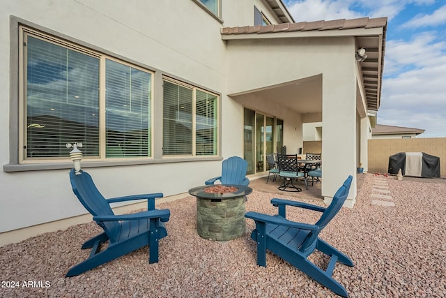 view of patio with a fire pit and a grill