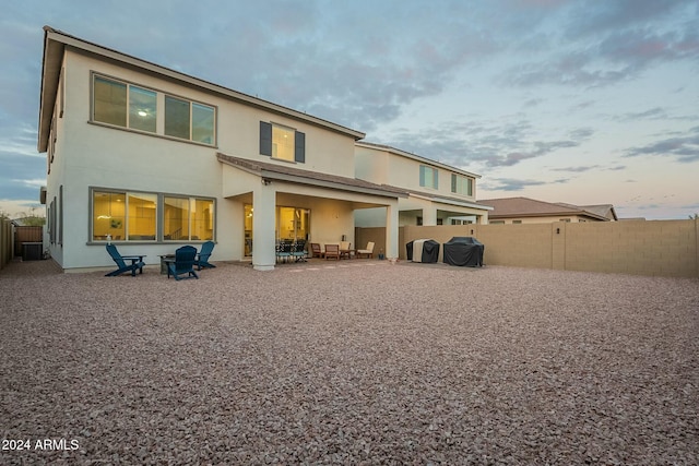 back of property with cooling unit and a patio