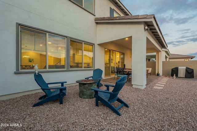 rear view of house featuring a patio and a fire pit