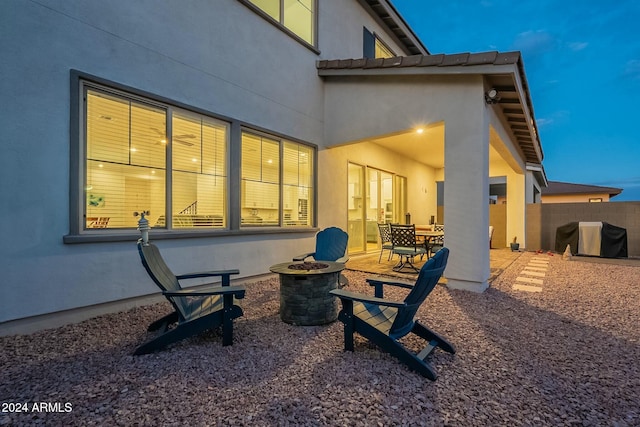 rear view of house with an outdoor fire pit and a patio area