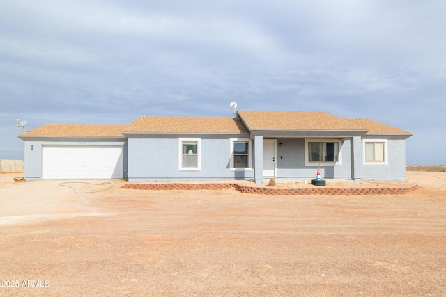 ranch-style home featuring a garage and covered porch