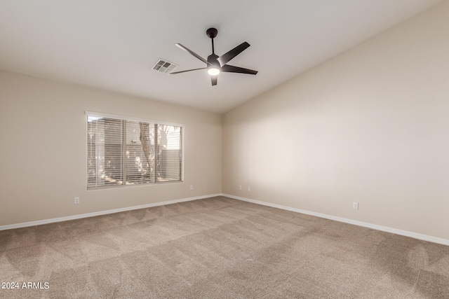 carpeted empty room featuring lofted ceiling and ceiling fan