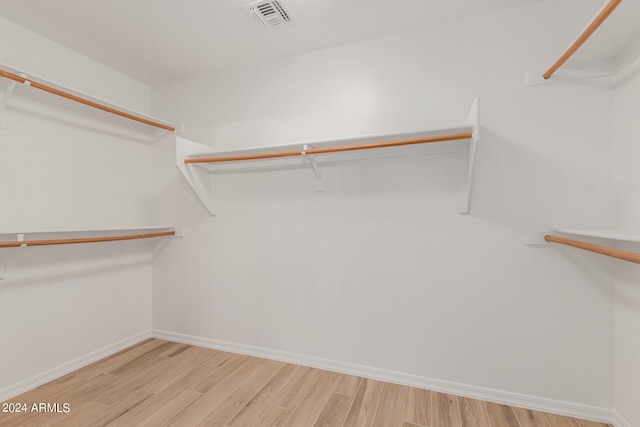 spacious closet featuring light hardwood / wood-style flooring