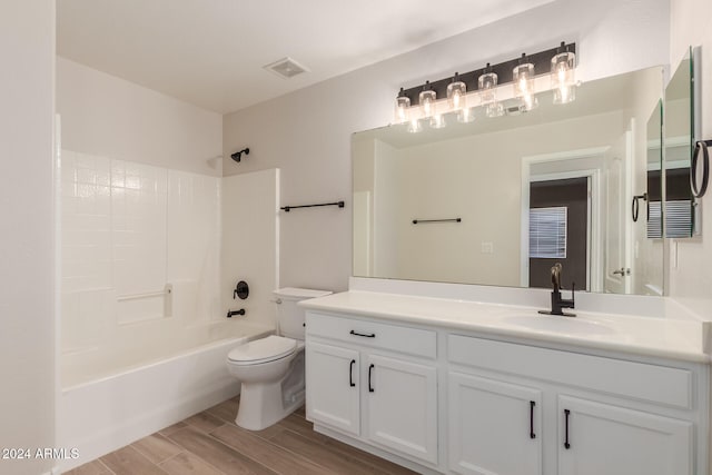 full bathroom featuring bathing tub / shower combination, hardwood / wood-style floors, vanity, and toilet