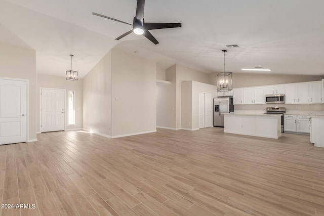 unfurnished living room with ceiling fan with notable chandelier, light hardwood / wood-style flooring, and high vaulted ceiling