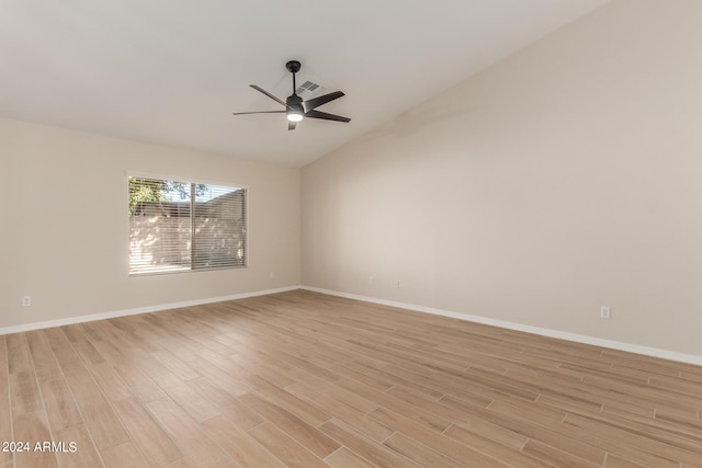 spare room featuring lofted ceiling, light hardwood / wood-style floors, and ceiling fan