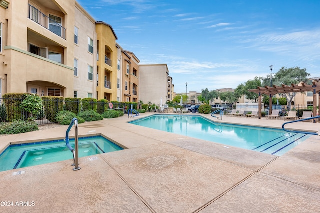 view of pool with a community hot tub, a pergola, and a patio area