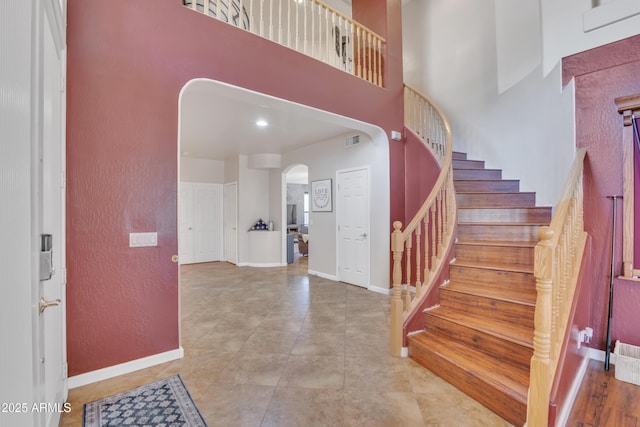 2642 S Joplin, Mesa, AZ 85209 - tiled foyer entrance with arched walkways, stairs, and a towering ceiling