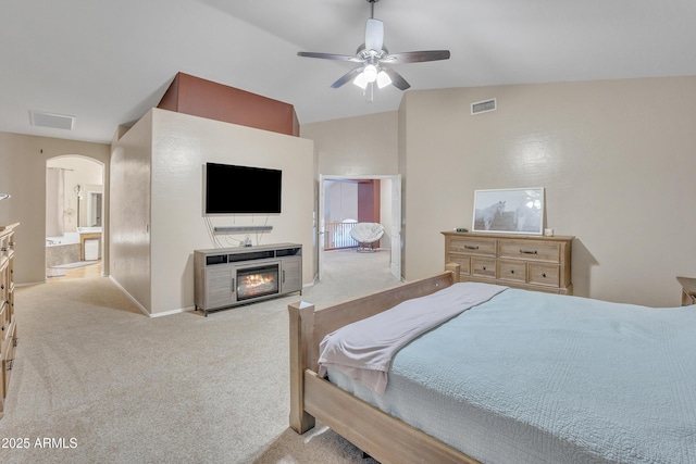 2642 S Joplin, Mesa, AZ 85209 - carpeted bedroom with arched walkways, vaulted ceiling, a glass covered fireplace, ensuite bath, and ceiling fan