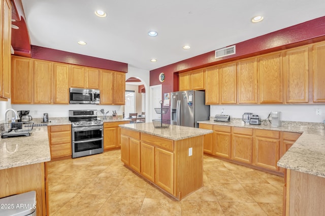 2642 S Joplin, Mesa, AZ 85209 - kitchen with appliances with stainless steel finishes, arched walkways, light stone counters, and recessed lighting