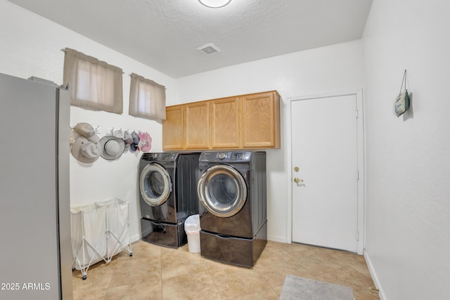 2642 S Joplin, Mesa, AZ 85209 - laundry room with washing machine and dryer, cabinet space, a textured ceiling, and light tile patterned floors