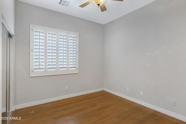 unfurnished room with ceiling fan and wood-type flooring