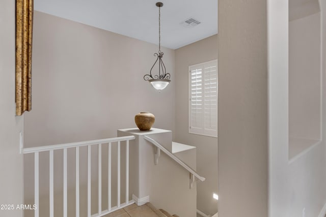 stairway with tile patterned floors