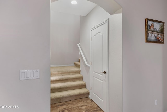 stairs with wood-type flooring