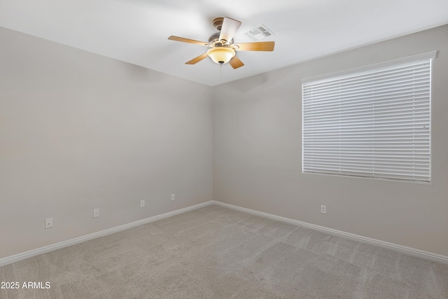 empty room with light colored carpet and ceiling fan