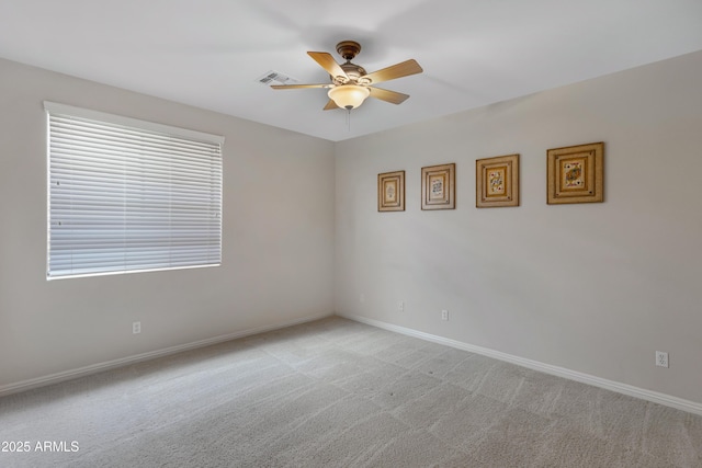 carpeted spare room with ceiling fan