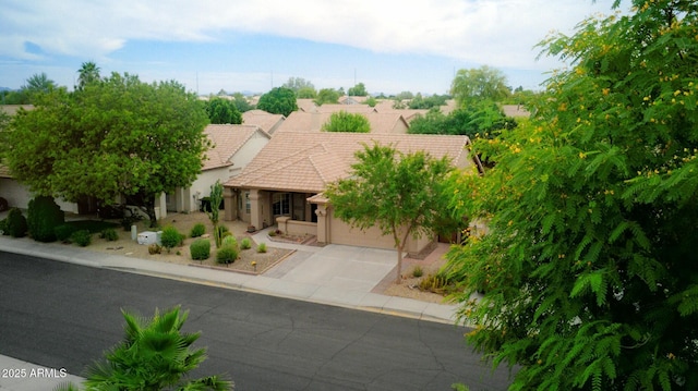 5451 W Folley St, Chandler, AZ 85226 - view of front of property featuring a garage, concrete driveway, a tiled roof, and stucco siding