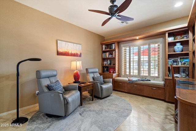 sitting room featuring ceiling fan, visible vents, and light tile patterned floors
