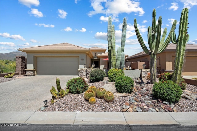 prairie-style house with a garage, stucco siding, concrete driveway, and a tiled roof