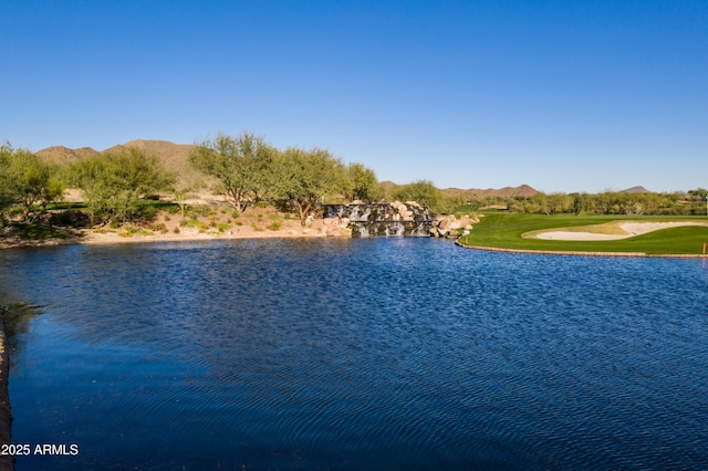 property view of water with a mountain view and golf course view