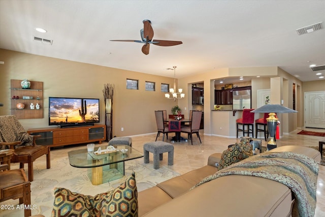 living area with visible vents, recessed lighting, baseboards, and ceiling fan with notable chandelier