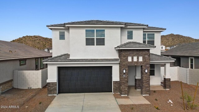 view of front of property featuring a mountain view and a garage