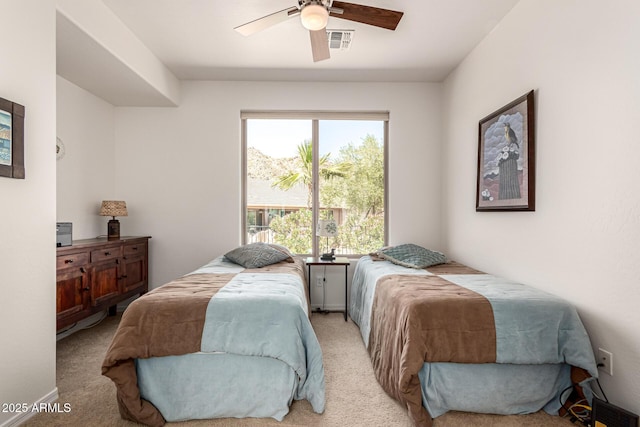 bedroom featuring light colored carpet, visible vents, and ceiling fan