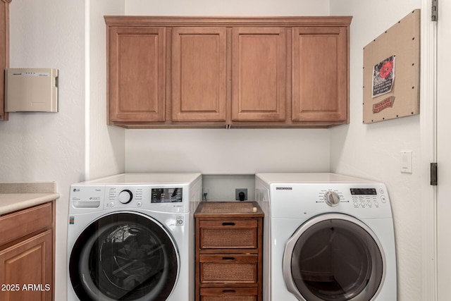laundry room with cabinet space and washer and clothes dryer