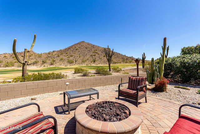 view of patio featuring a mountain view and an outdoor fire pit