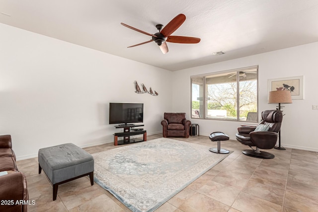 living room featuring visible vents, baseboards, and ceiling fan