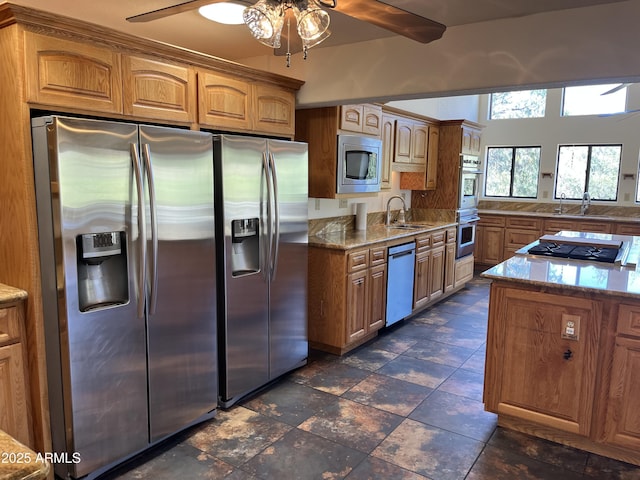 2160 S Moonlight Dr, Star Valley, AZ 85541 - kitchen featuring stainless steel appliances, a ceiling fan, light stone countertops, and brown cabinets