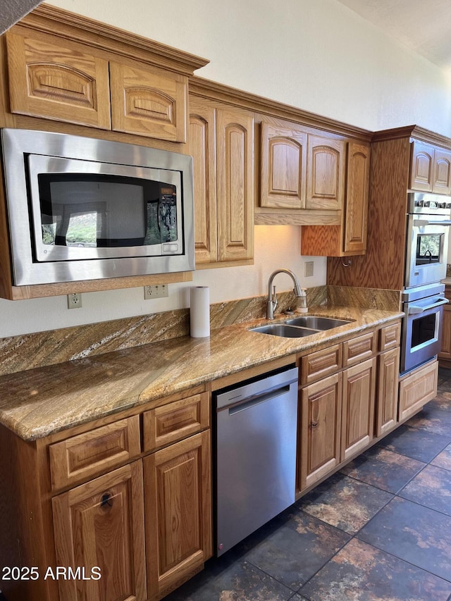 2160 S Moonlight Dr, Star Valley, AZ 85541 - kitchen with appliances with stainless steel finishes, brown cabinets, and light stone countertops