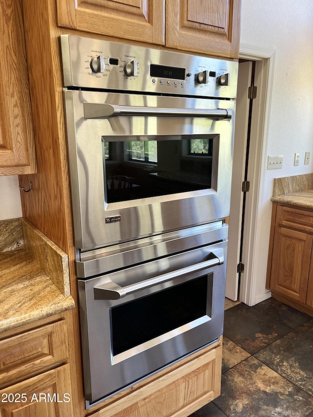 2160 S Moonlight Dr, Star Valley, AZ 85541 - kitchen with stainless steel double oven, light stone countertops, and brown cabinets
