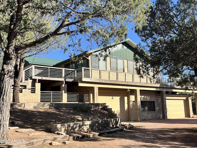 2160 S Moonlight Dr, Star Valley, AZ 85541 - view of front facade featuring dirt driveway, a balcony, a garage, and brick siding