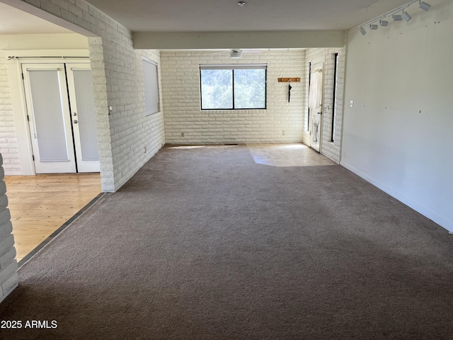 2160 S Moonlight Dr, Star Valley, AZ 85541 - unfurnished living room featuring brick wall, french doors, and carpet