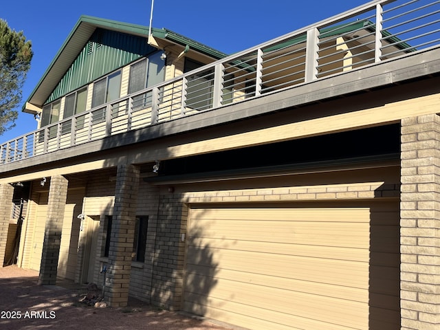 2160 S Moonlight Dr, Star Valley, AZ 85541 - view of side of property featuring a balcony, brick siding, and a garage