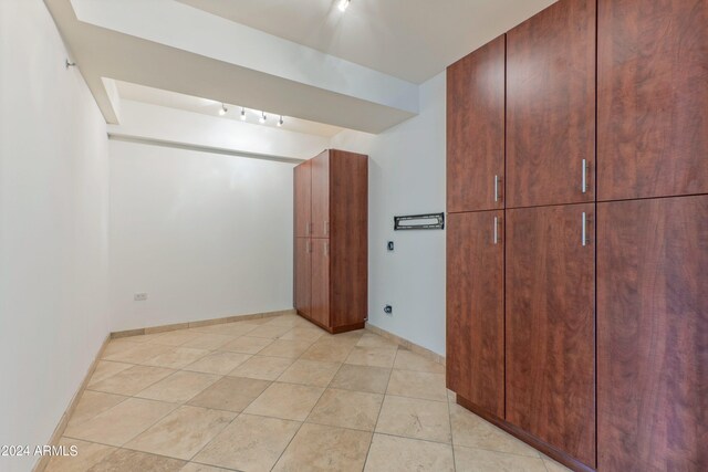 kitchen featuring decorative backsplash, appliances with stainless steel finishes, sink, dark stone countertops, and light tile patterned flooring