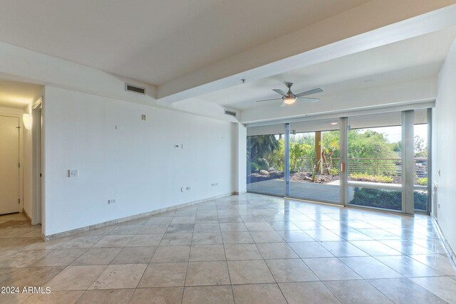 unfurnished living room featuring ceiling fan and light tile patterned floors