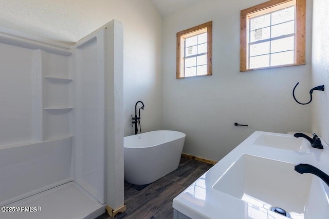 24 N County Road N3101, Vernon, AZ 85940 - full bathroom featuring wood finished floors, a freestanding tub, a shower, baseboards, and dual sinks